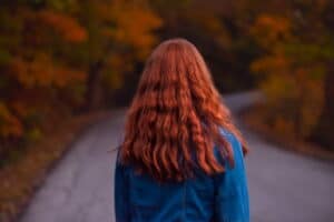 A red-haired girl walking in the streets