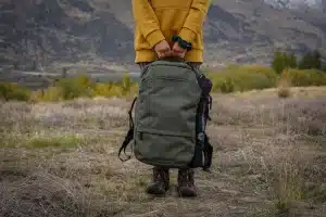 A Man Holding a Backpack Choosing The Best Carry On Backpack UK